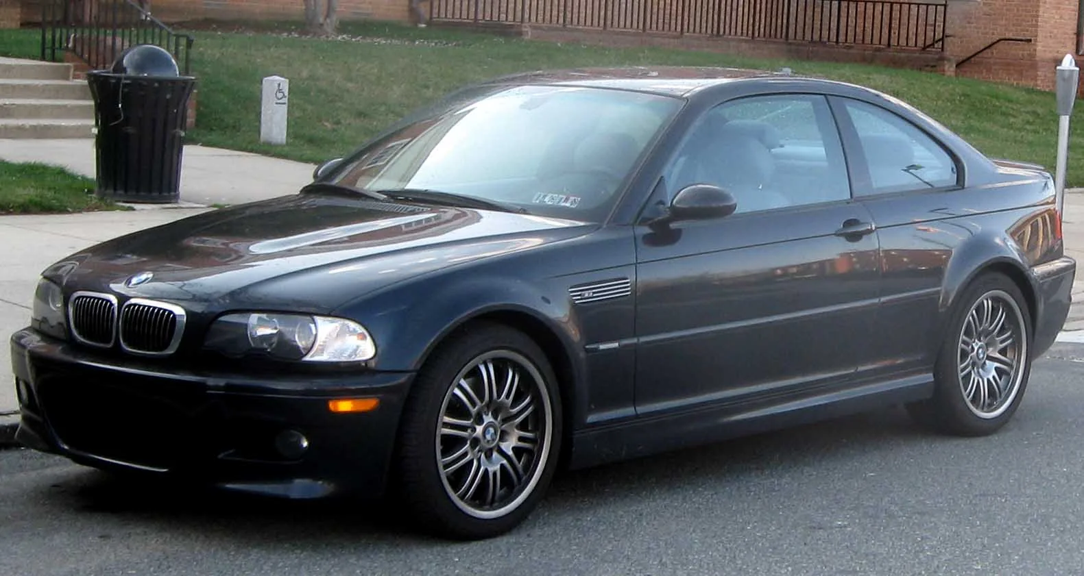 Dark blue BMW M3 E46 coupe parked outdoors, front three-quarter view.